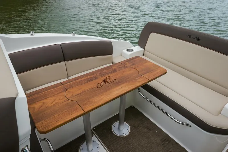Slide: The Image of Manufacturer Provided Image: 2016 Sea Ray 260 Sundancer boat interior with wooden table and cushioned seating. - 6