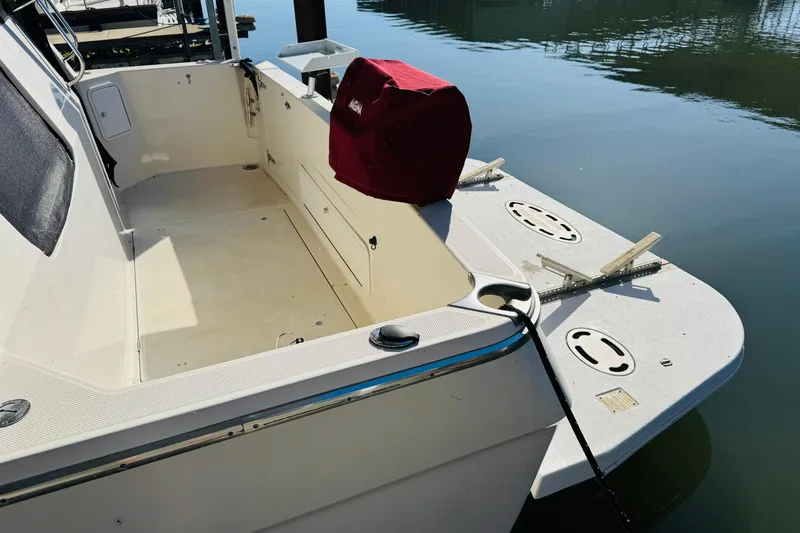 Slide: The Image of 1995 Bayliner 4587 Motoryacht stern view with spacious deck and water backdrop. - 10