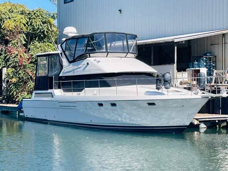 Slide: The Image of 1995 Bayliner 4587 Motoryacht docked near a marina. - 2