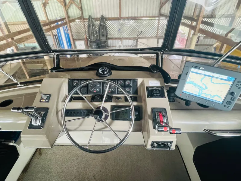 Slide: The Image of 1995 Bayliner 4587 Motoryacht helm with navigation equipment and steering wheel. - 23