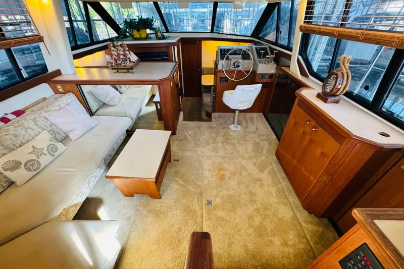 Slide: The Image of Luxurious interior of a 1995 Bayliner 4587 Motoryacht with plush seating and elegant wood finishes. - 25