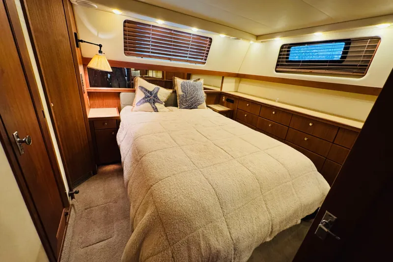 Slide: The Image of Luxurious bedroom interior of 1995 Bayliner 4587 Motoryacht with cozy bedding and wooden accents. - 39
