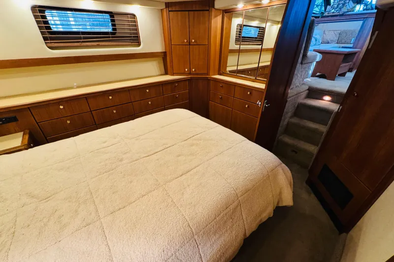 Slide: The Image of Luxurious interior of 1995 Bayliner 4587 Motoryacht with cozy bedroom and elegant wood cabinetry. - 40