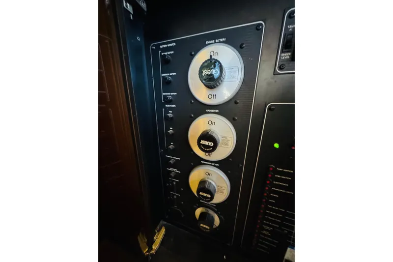Slide: The Image of Control panel of a 1995 Bayliner 4587 Motoryacht, featuring battery and crossover switches. - 49