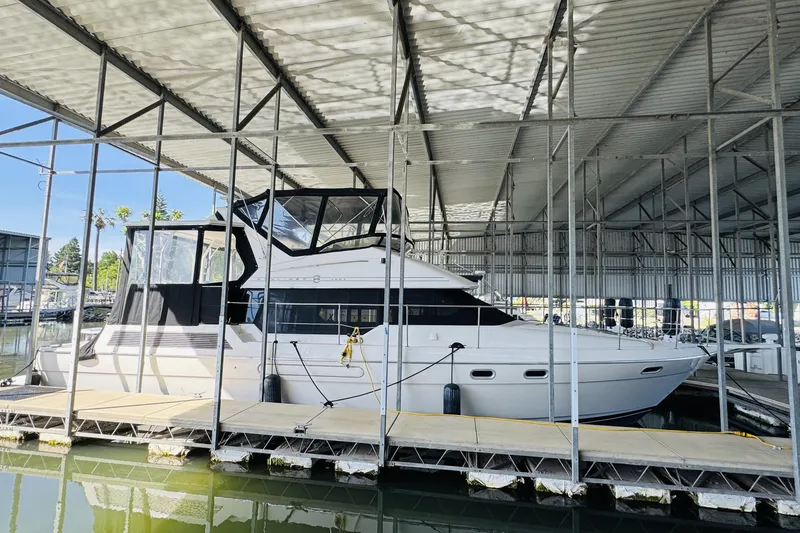 Slide: The Image of 1995 Bayliner 4587 Motoryacht docked in a covered marina. - 5