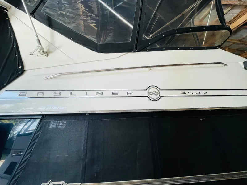 Slide: The Image of 1995 Bayliner 4587 Motoryacht side view in a covered dock. - 7