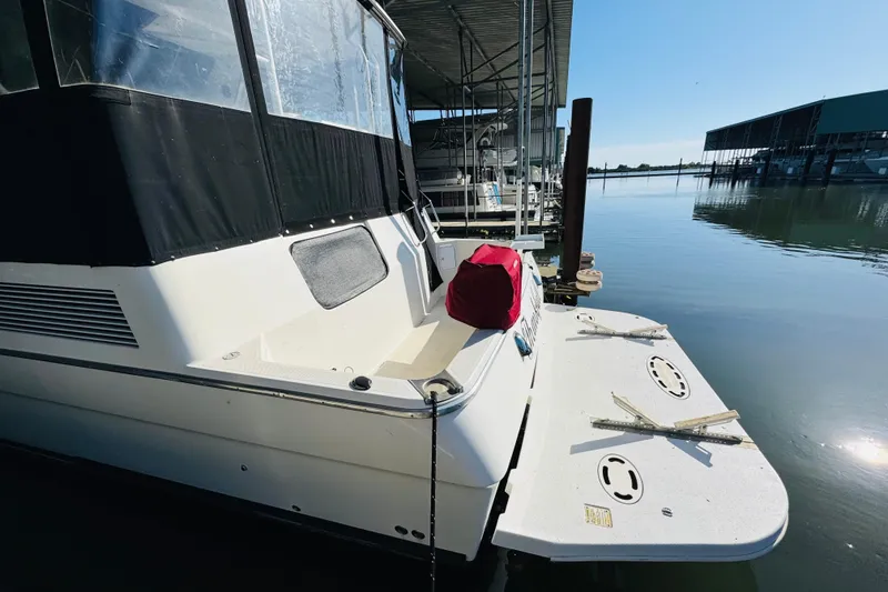 Slide: The Image of 1995 Bayliner 4587 Motoryacht docked at marina with calm water. - 8