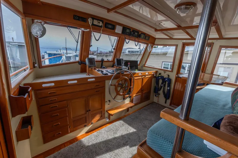 Slide: The Image of Interior of 1986 Kadey-Krogen 42 boat with wooden helm and navigation equipment. - 10