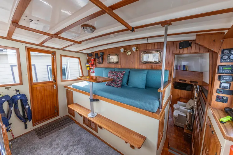 Slide: The Image of Interior of 1986 Kadey-Krogen 42 boat with wooden accents and cozy seating area. - 11