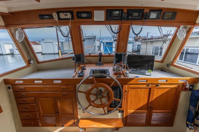 Slide: The Image of 1986 Kadey-Krogen 42 boat helm with wooden cabinetry and navigation equipment. - 13