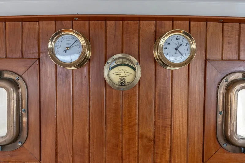 Slide: The Image of Wooden panel with brass clock and barometer on 1986 Kadey-Krogen 42 yacht. - 16