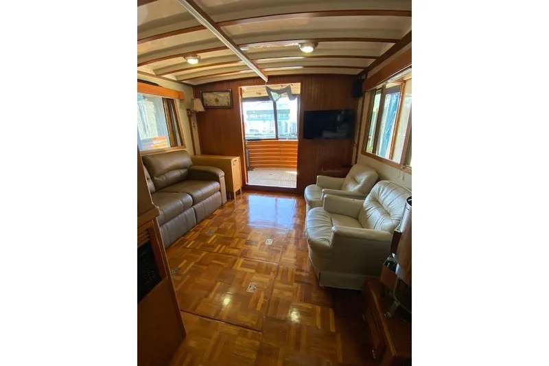 Slide: The Image of Interior of 1986 Kadey-Krogen 42 yacht with leather seating and wooden flooring. - 2