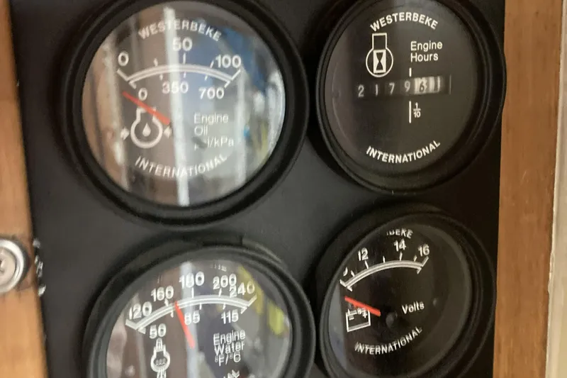 Slide: The Image of Close-up of Kadey-Krogen 42 engine gauges, displaying oil pressure, engine hours, water temperature, and voltage. - 20