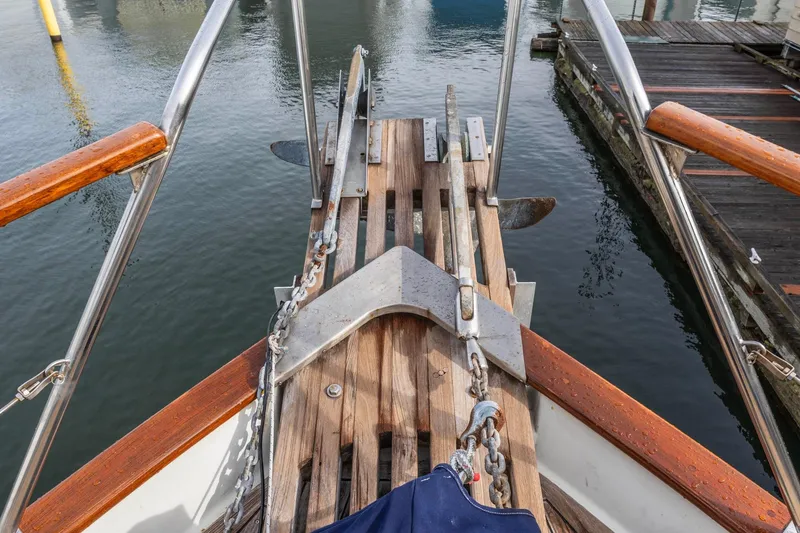 Slide: The Image of Bow of 1986 Kadey-Krogen 42 yacht with anchor and wooden deck details. - 29