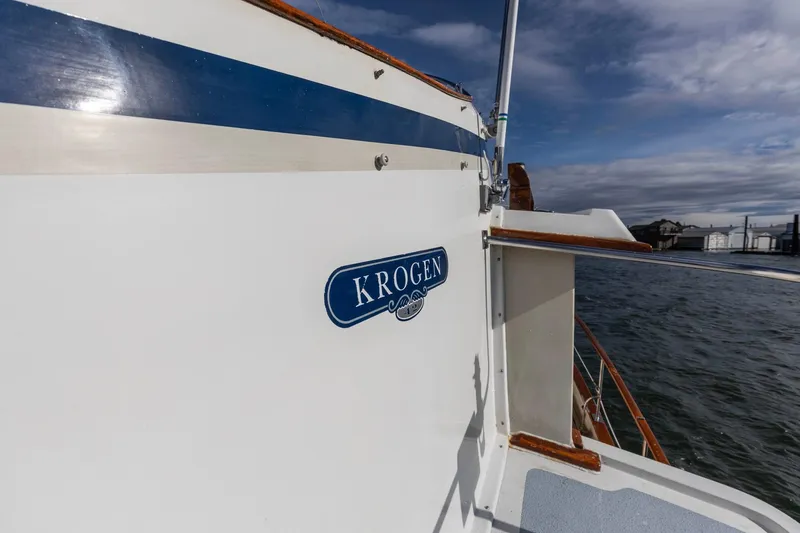 Slide: The Image of 1986 Kadey-Krogen 42 yacht on water, featuring blue and white exterior design. - 33