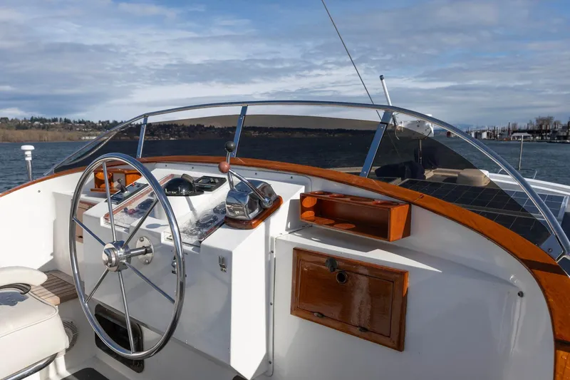 Slide: The Image of 1986 Kadey-Krogen 42 yacht helm with wooden accents and scenic water view. - 34