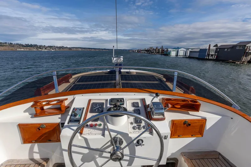 Slide: The Image of Helm of 1986 Kadey-Krogen 42 yacht with scenic waterway view. - 35