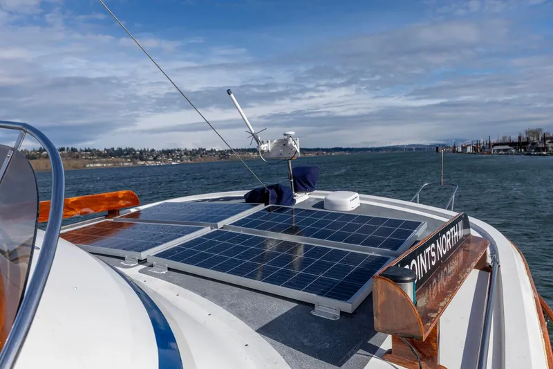 Slide: The Image of 1986 Kadey-Krogen 42 boat with solar panels on deck, cruising on a sunny day. - 36