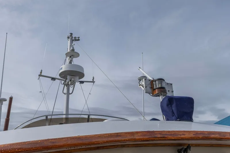 Slide: The Image of 1986 Kadey-Krogen 42 boat mast and radar equipment against cloudy sky. - 37