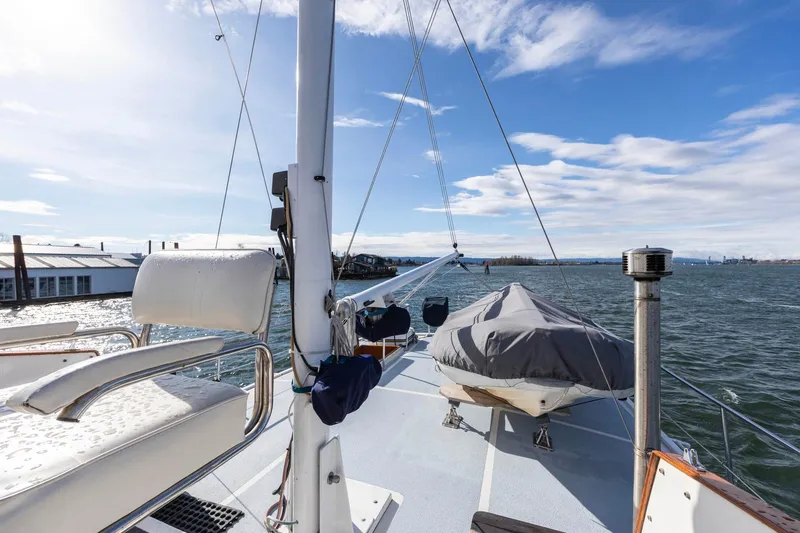 Slide: The Image of 1986 Kadey-Krogen 42 yacht deck with seating, covered equipment, and ocean view. - 38