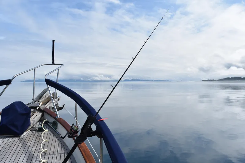 Slide: The Image of Bow of 1986 Kadey-Krogen 42 with fishing rod on calm waters. - 39