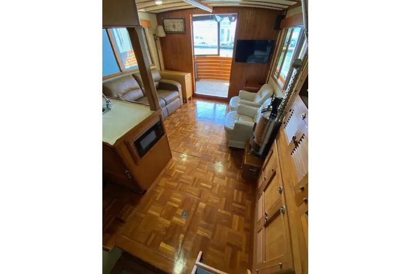 Slide: The Image of Interior of 1986 Kadey-Krogen 42 yacht with wood flooring and comfortable seating. - 4