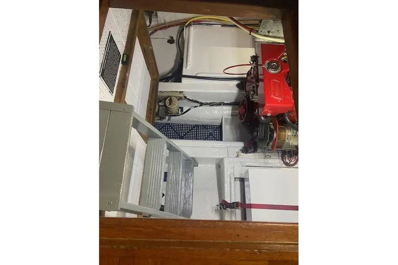Slide: The Image of Engine room of a 1986 Kadey-Krogen 42 boat, featuring mechanical components and wiring. - 40