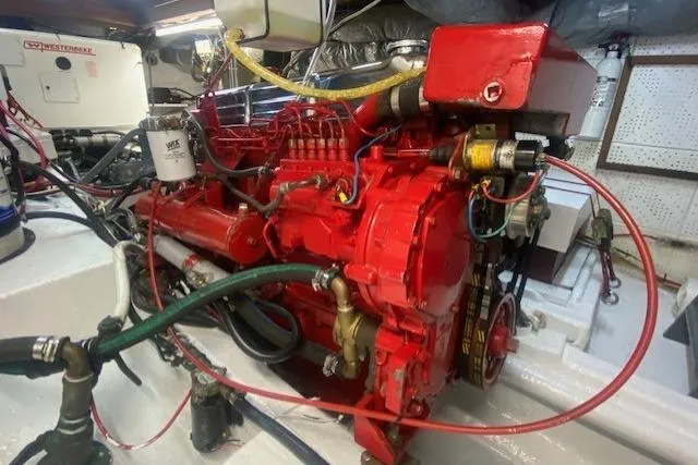 Slide: The Image of Engine room of a 1986 Kadey-Krogen 42, featuring a red marine engine. - 41