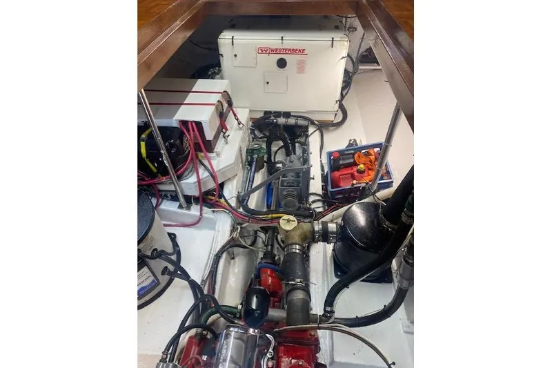 Slide: The Image of Engine room of a 1986 Kadey-Krogen 42 boat with visible machinery and wiring. - 43