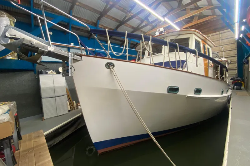 Slide: The Image of 1986 Kadey-Krogen 42 yacht docked indoors, showcasing sleek design and sturdy build. - 46