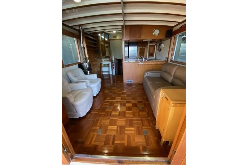 Slide: The Image of Interior of 1986 Kadey-Krogen 42 yacht with wooden flooring and comfortable seating. - 5
