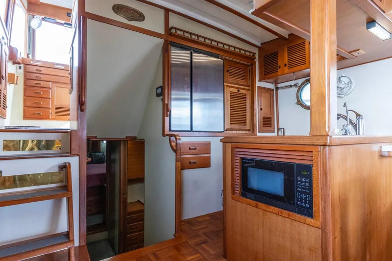 Slide: The Image of Interior of 1986 Kadey-Krogen 42 yacht with wooden cabinetry and built-in microwave. - 7