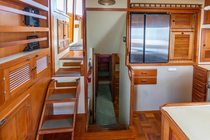 Slide: The Image of Interior of 1986 Kadey-Krogen 42 yacht with wooden cabinetry and stairs. - 8