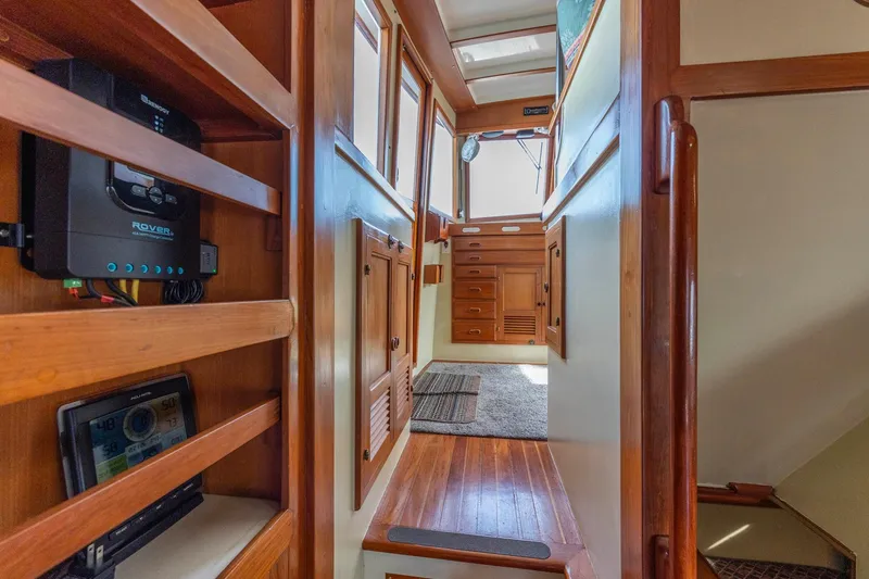 Slide: The Image of Interior of 1986 Kadey-Krogen 42 yacht with wooden cabinetry and modern electronics. - 9