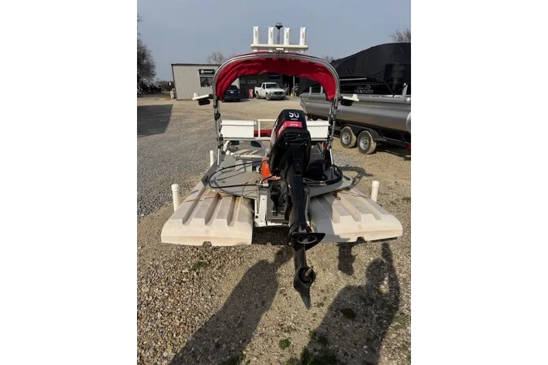 Slide: The Image of 2002 CRAIG Cat boat with outboard motor on gravel lot. - 5