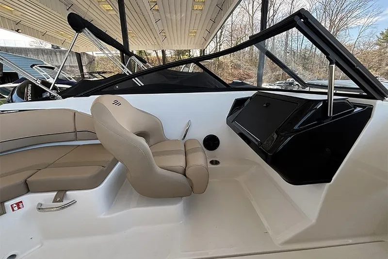 Slide: The Image of 2026 Bayliner V20i boat interior with tan seating and modern design. - 11