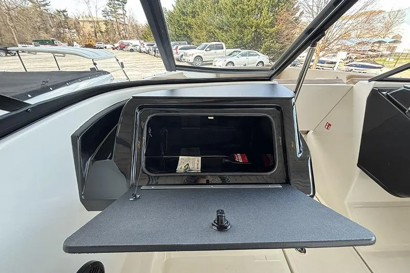 Slide: The Image of 2026 Bayliner V20i boat interior with beige seating and storage compartments. - 12