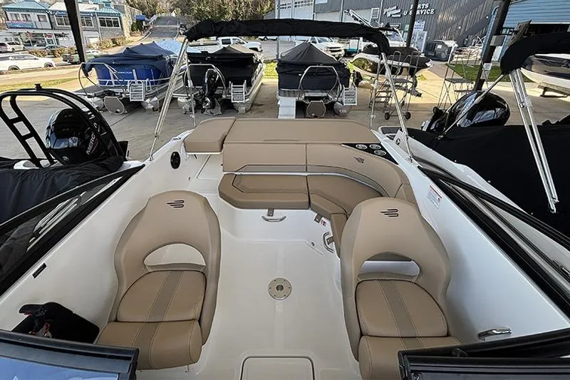 Slide: The Image of 2026 Bayliner V20i boat interior with open storage compartment and beige seating. - 13