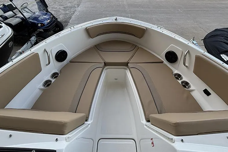 Slide: The Image of 2026 Bayliner V20i boat dashboard with steering wheel and control panel. - 16