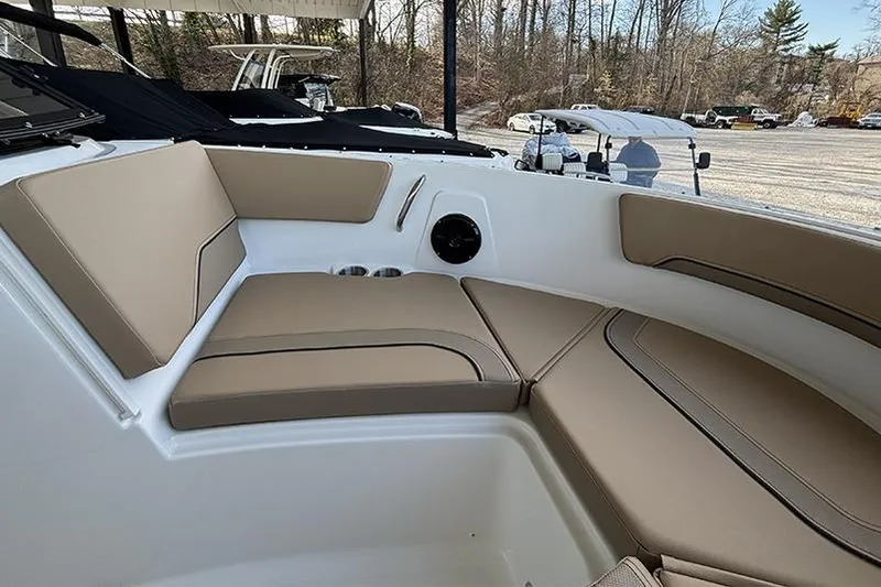 Slide: The Image of Interior of 2026 Bayliner V20i boat with beige seating and sleek dashboard design. - 17