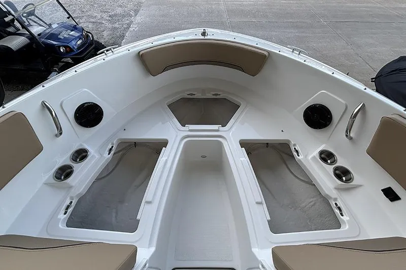 Slide: The Image of 2026 Bayliner V20i boat dashboard with open storage compartment. - 18