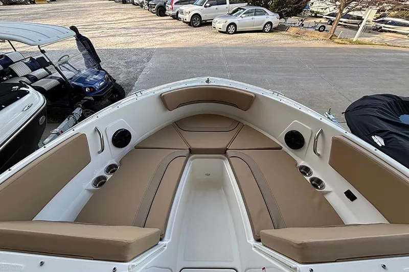 Slide: The Image of 2026 Bayliner V20i boat interior with beige seating and cup holders. - 22