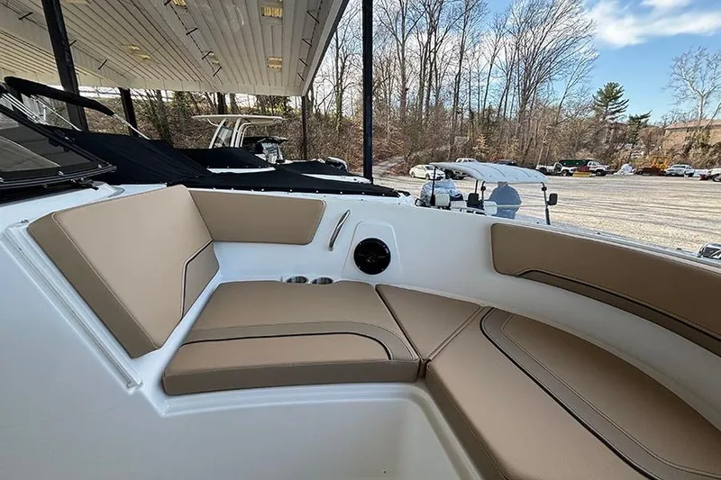 Slide: The Image of 2026 Bayliner V20i boat interior with beige seating under a covered area. - 23
