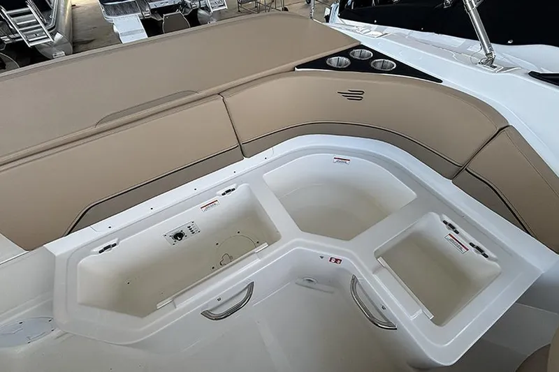 Slide: The Image of 2026 Bayliner V20i boat with canopy, parked on trailer under clear blue sky. - 6