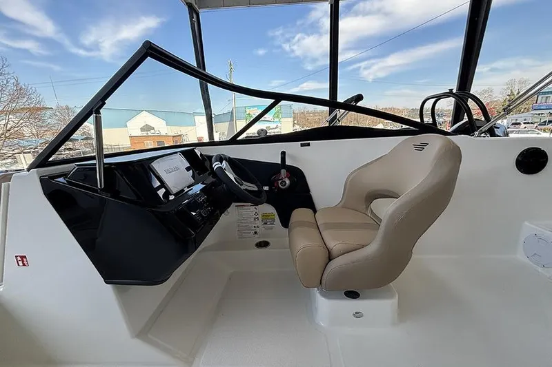 Slide: The Image of Interior view of 2026 Bayliner V20i boat with beige seating and dashboard. - 8