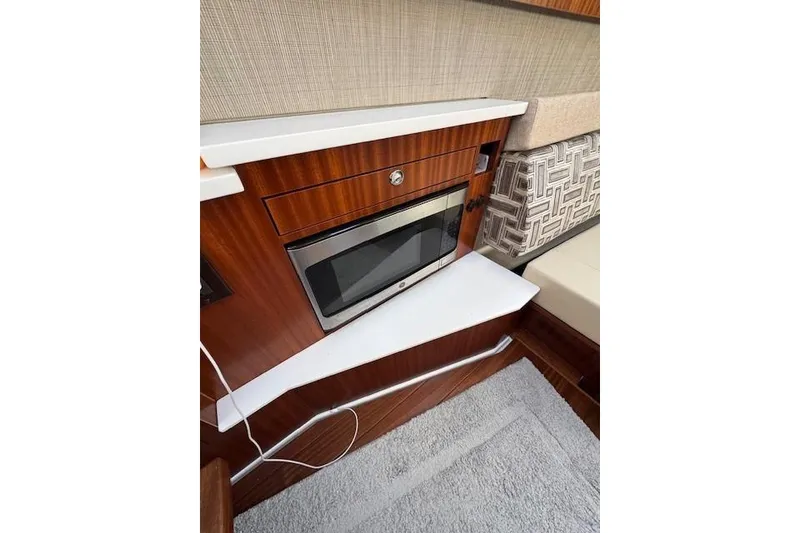 Slide: The Image of 2023 Pursuit S 428 Sport interior with microwave and stylish wood finish. - 10