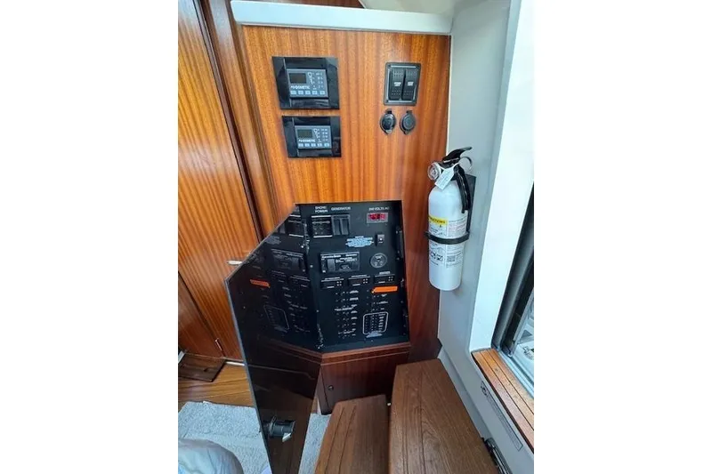 Slide: The Image of Control panel of 2023 Pursuit S 428 Sport boat with fire extinguisher. - 11
