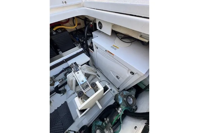 Slide: The Image of 2023 Pursuit S 428 Sport boat engine compartment with mechanical components and wiring. - 21