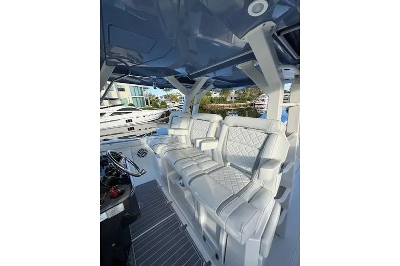 Slide: The Image of 2023 Pursuit S 428 Sport boat interior with luxurious white seating and modern design. - 3