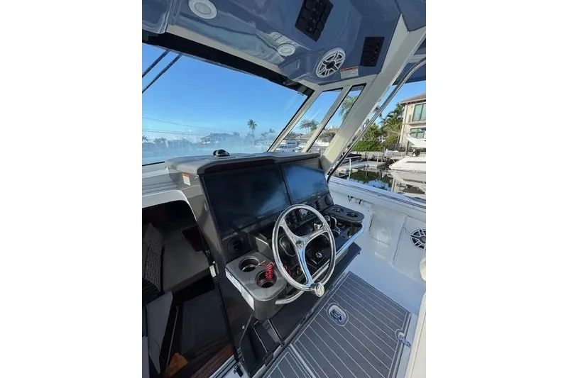 Slide: The Image of 2023 Pursuit S 428 Sport boat helm with modern controls and steering wheel. - 4
